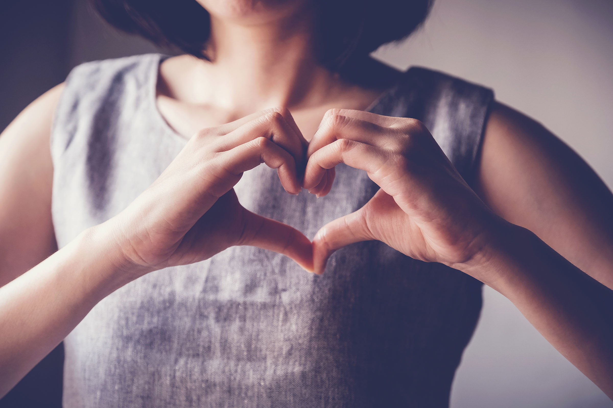 Young woman making her hands in heart shape.