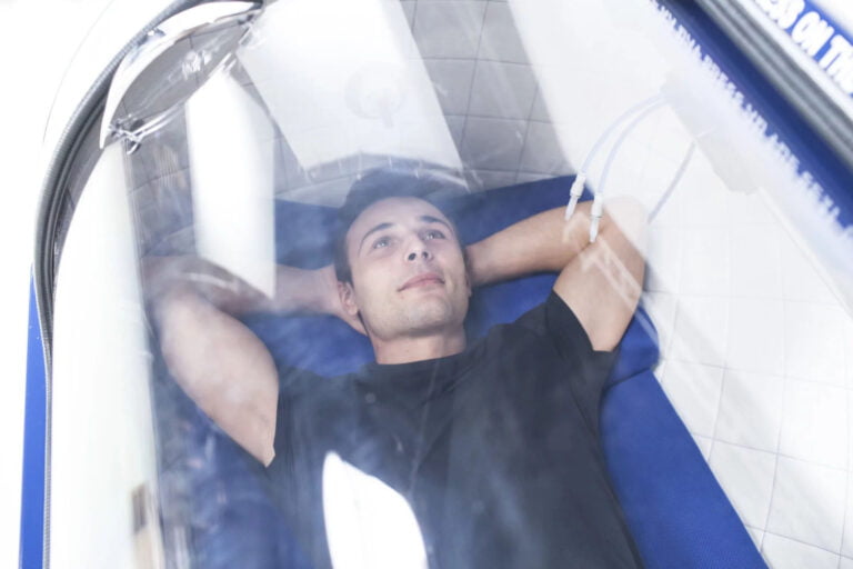 Man receiving HBOT Treatment. In oxygen chamber.