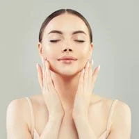 Woman touching her face after beauty treatment.