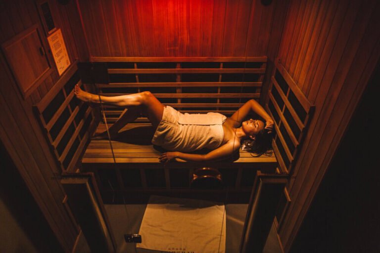 Woman receiving far infrared sauna treatment.